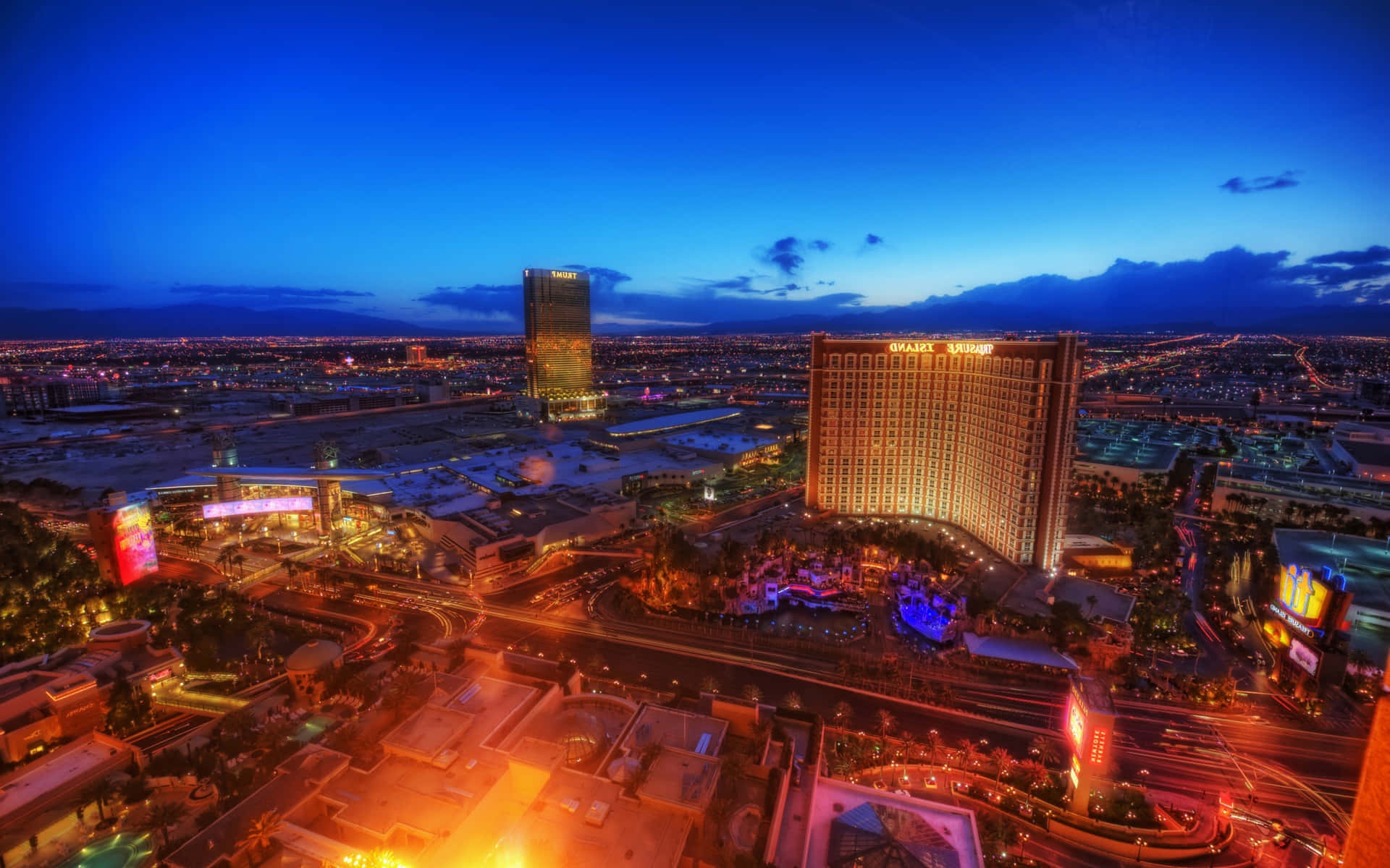 Las Vegas skyline at twilight with glowing hotels and neon lights.