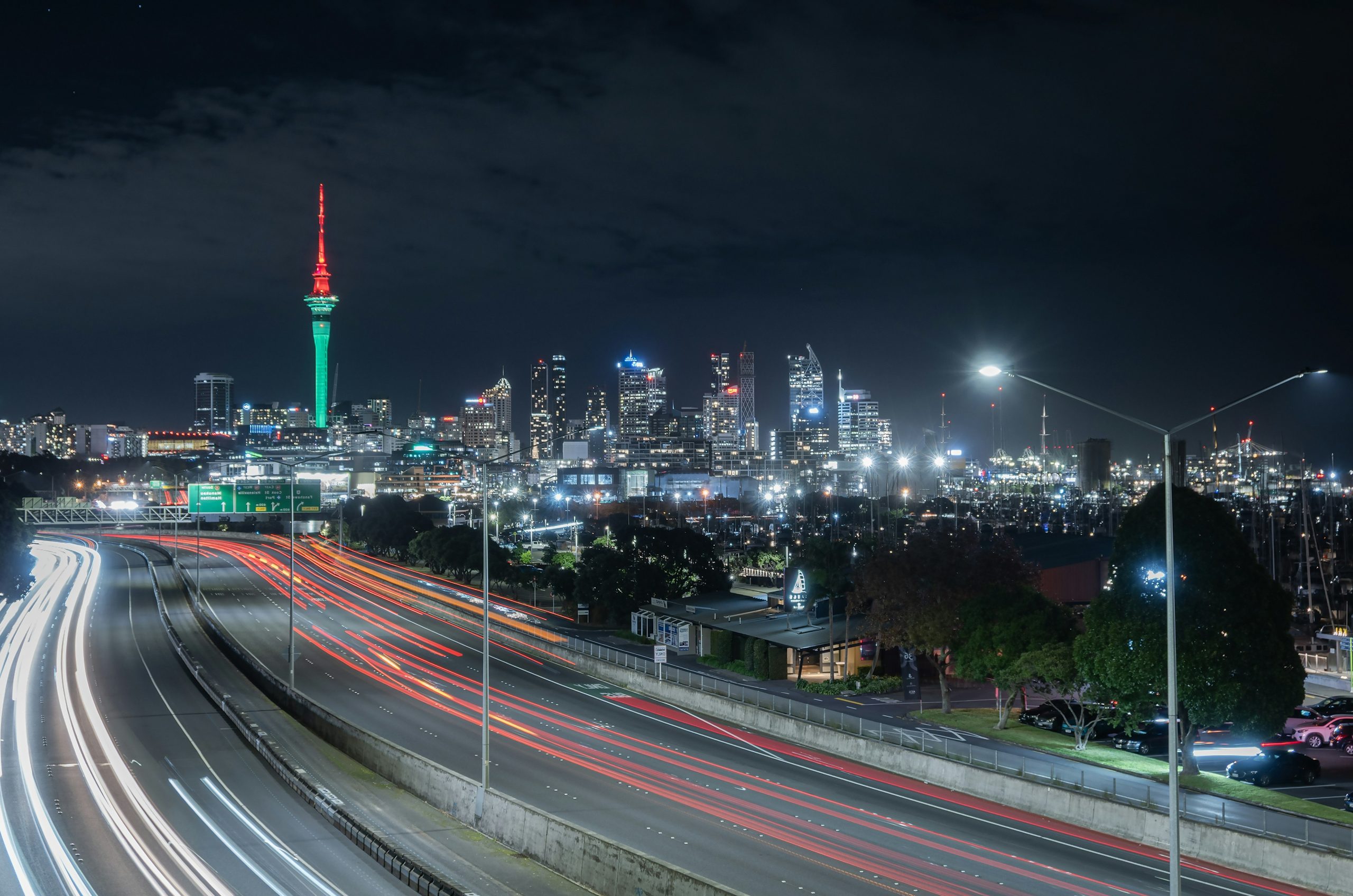 City skyline with light trails on highway at night